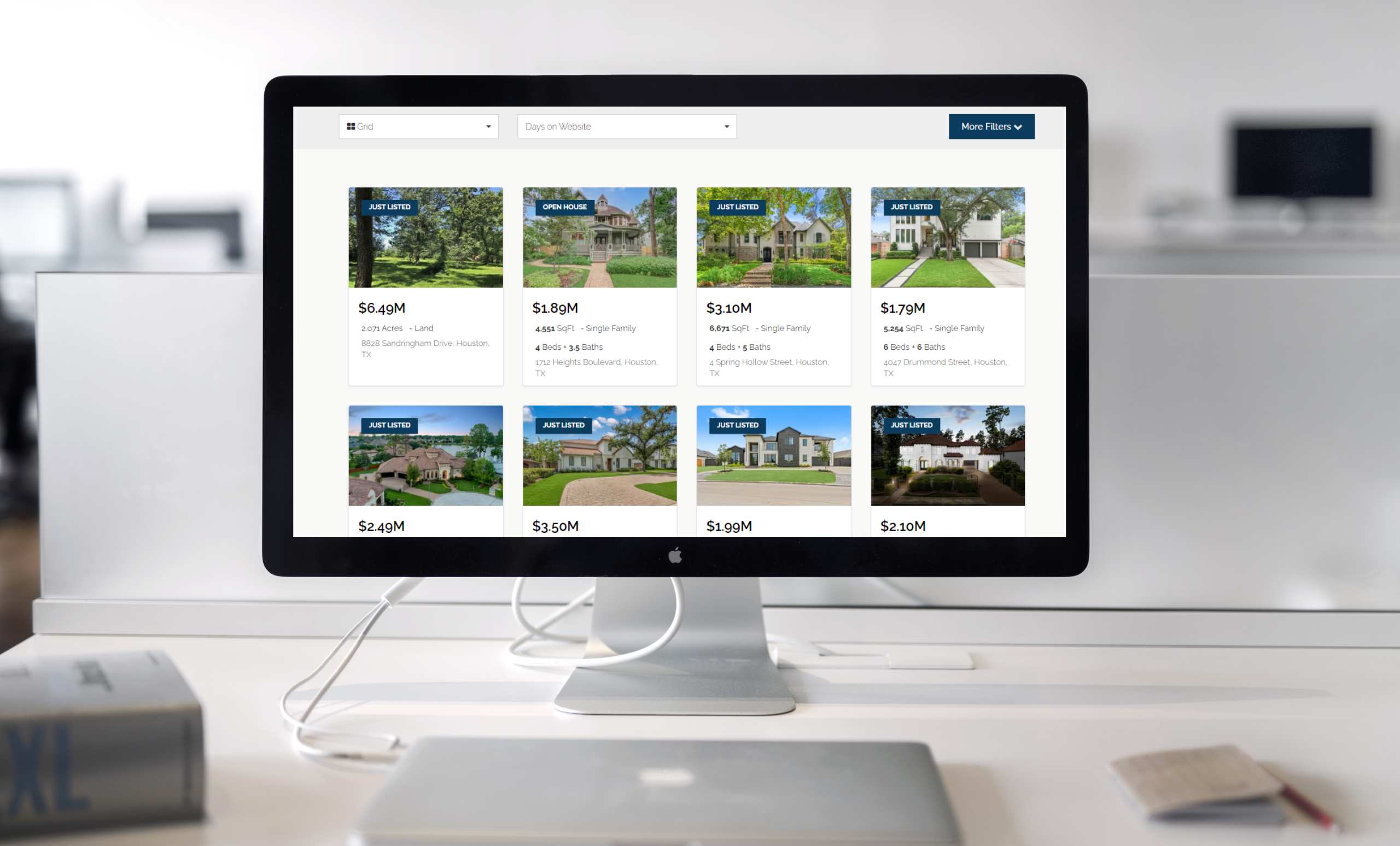photo of a computer with search results of homes for sale.