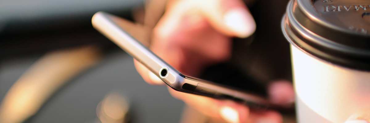 real estate agent using his phone to research different brokerages